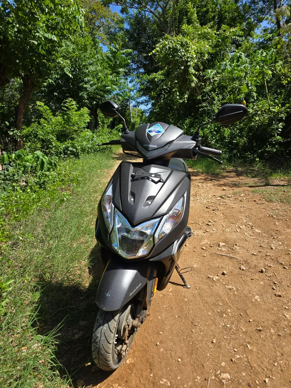 A scooter from the front, showing handlebars and mirrors