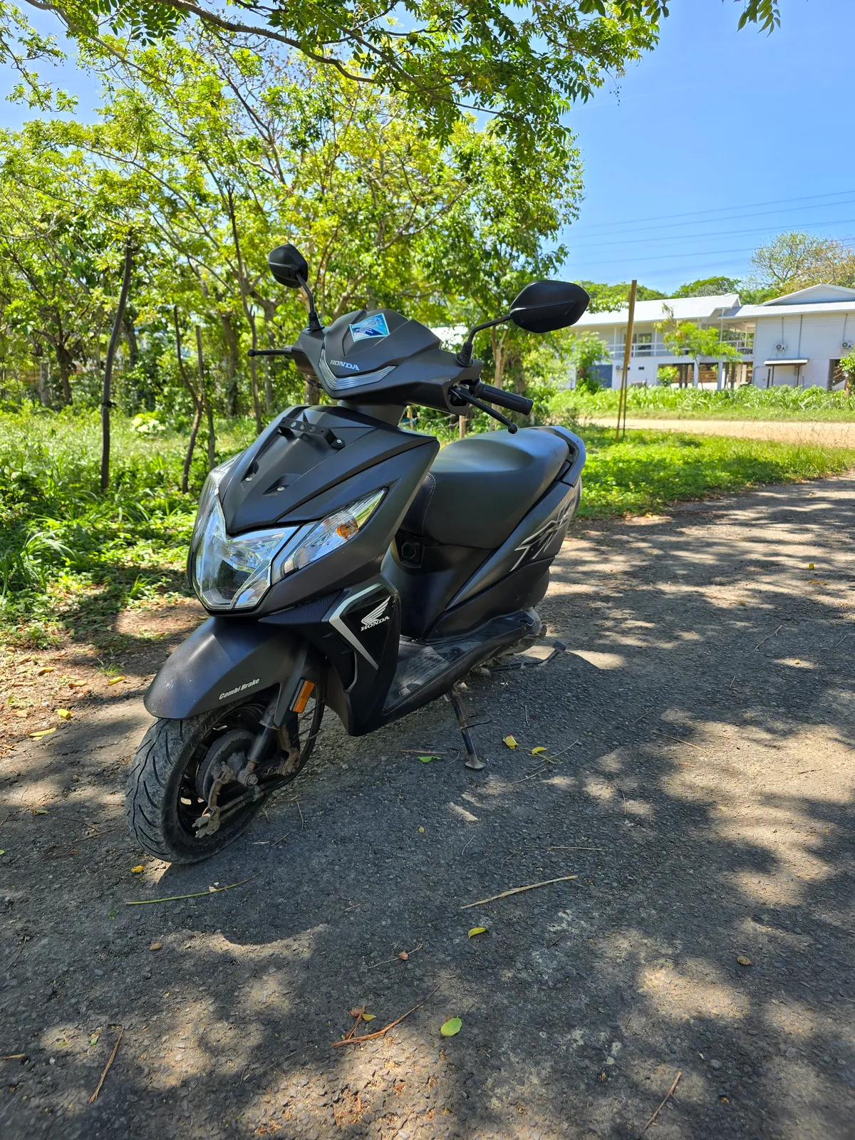 A scooter available to rent on Utila, front three-quarter view